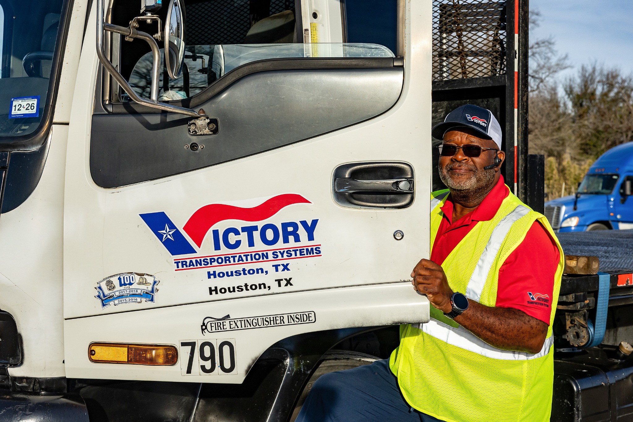 Victory Transportation owner operator beside a branded Hotshot truck